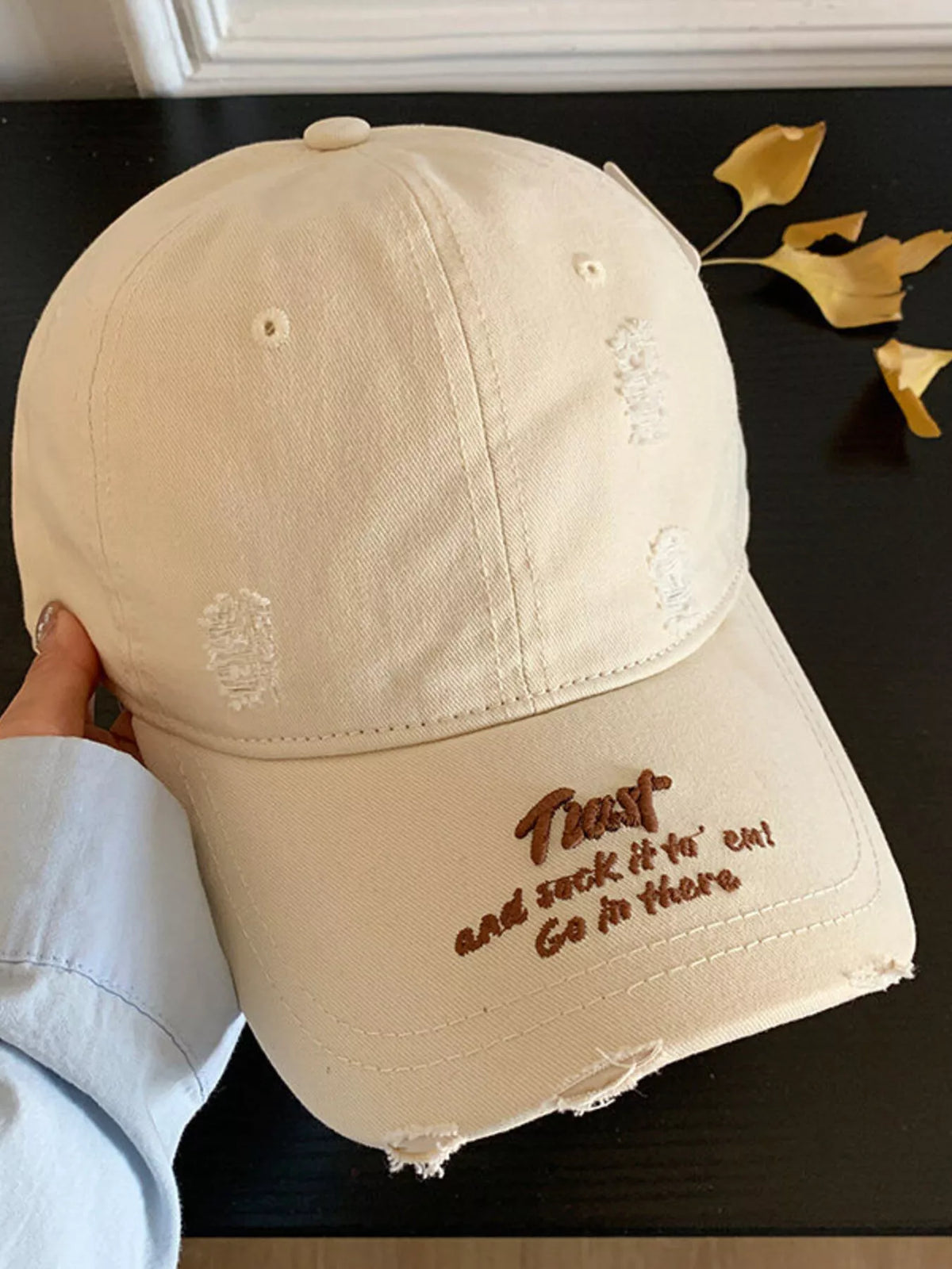Distressed cap shown in a soft dusty pink colourway