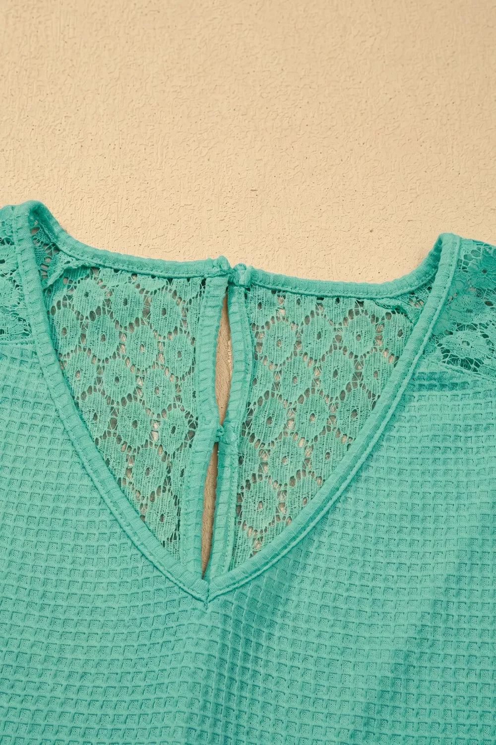 Turquoise waffle knit v neck top with lace trim front view