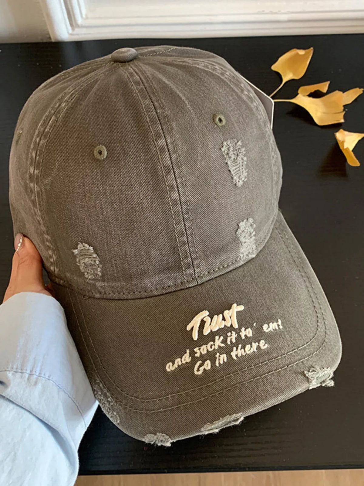 Detail of the distressed brim edge on the cotton cap