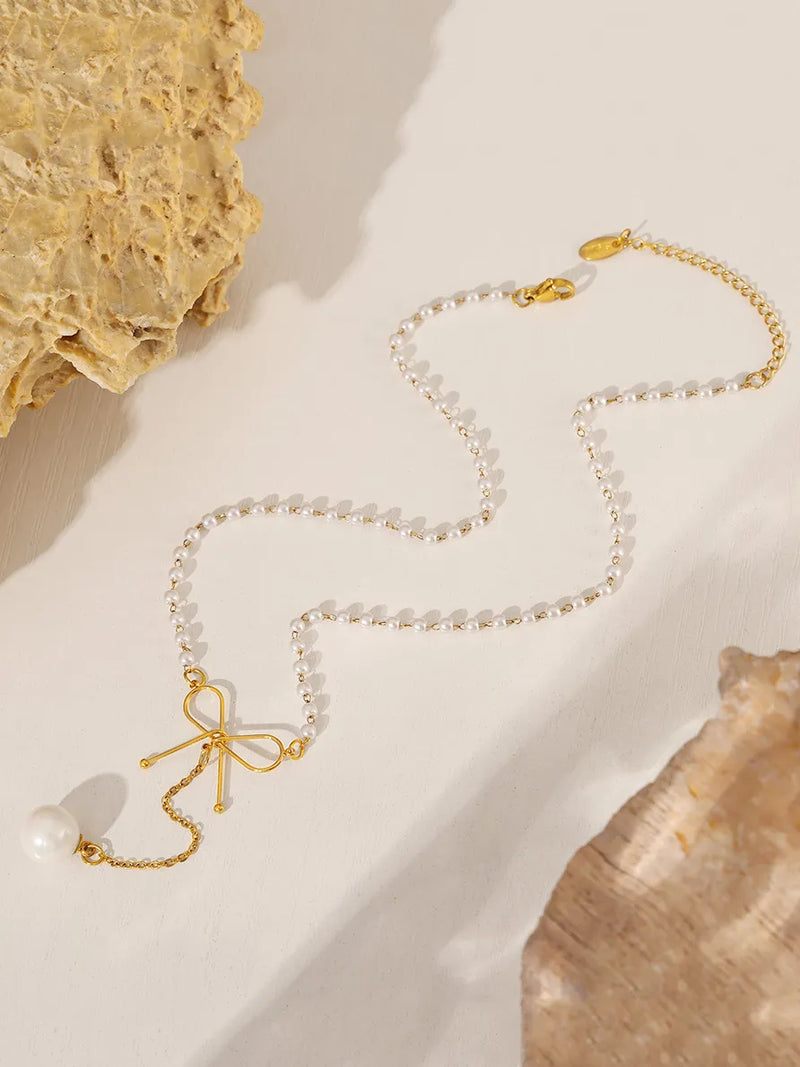 Pearl bow pendant necklace on model