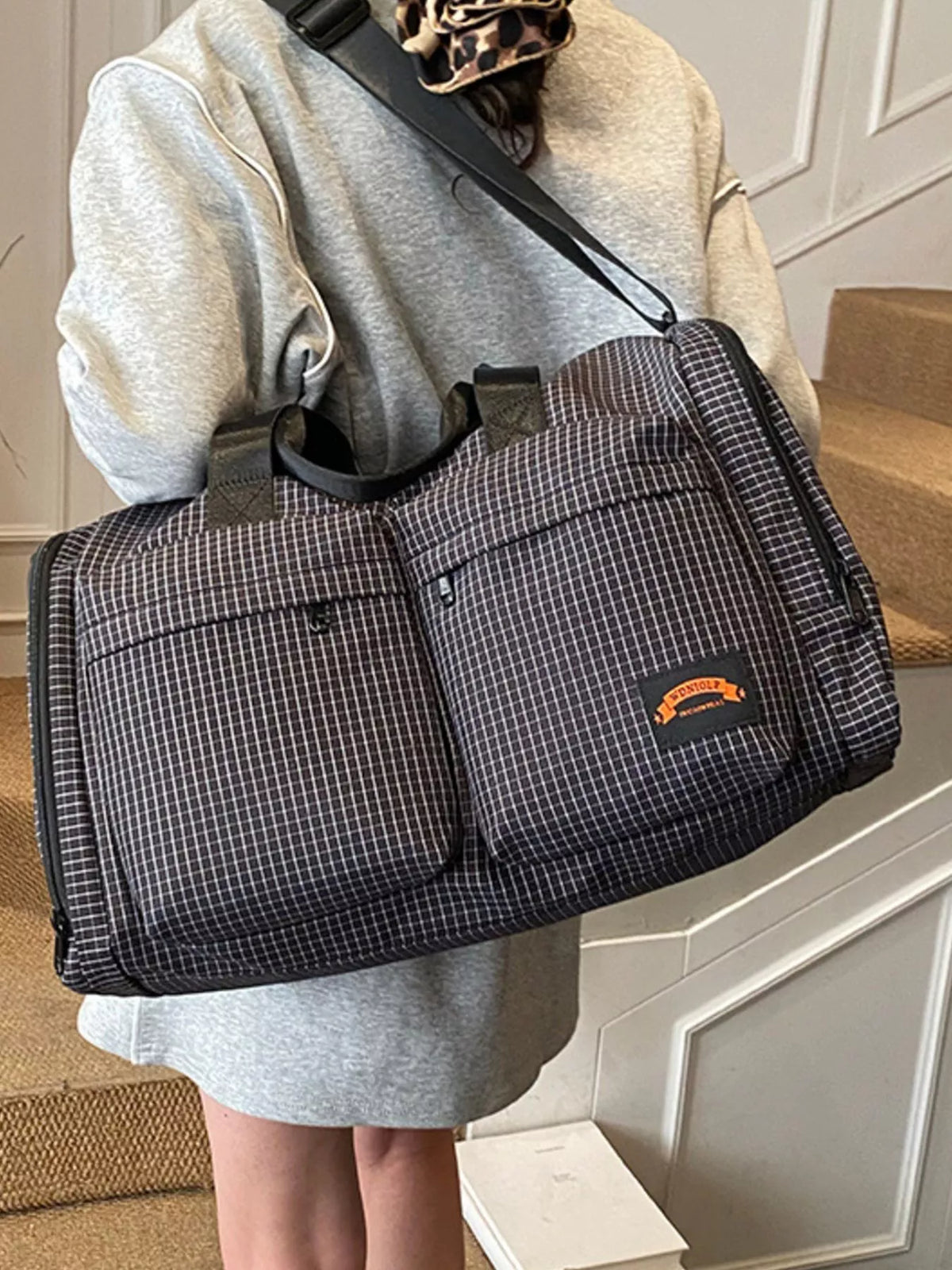 Plaid duffel bag zipper detail