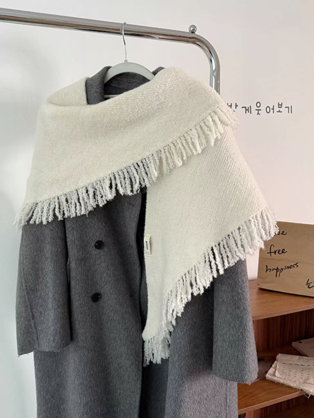 Cozy fringe knit scarf shown looped