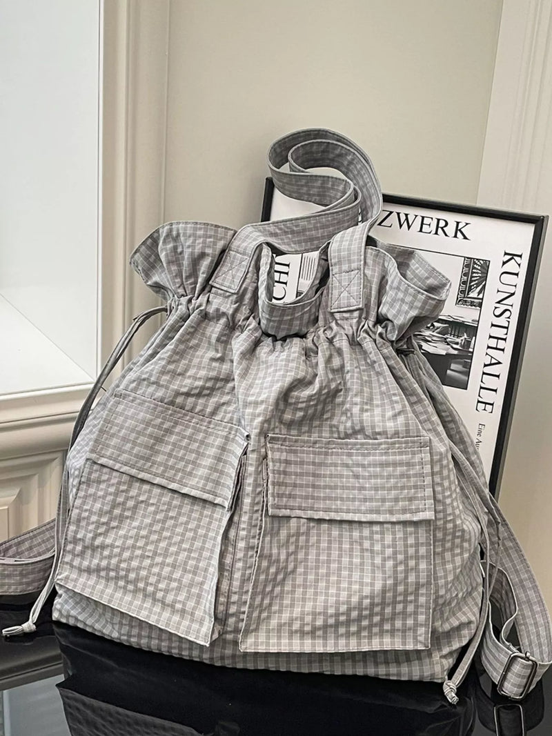 Grey convertible plaid drawstring nylon backpack front view