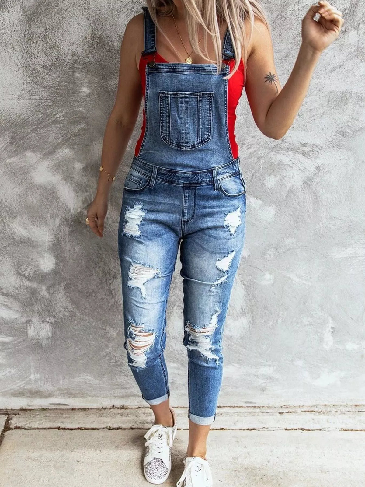 Distressed denim overalls back view