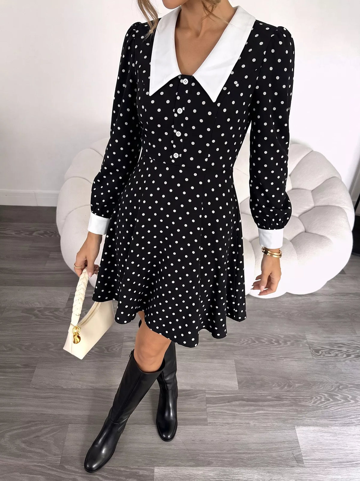 Black polka dot dress with a peter pan collar, front view