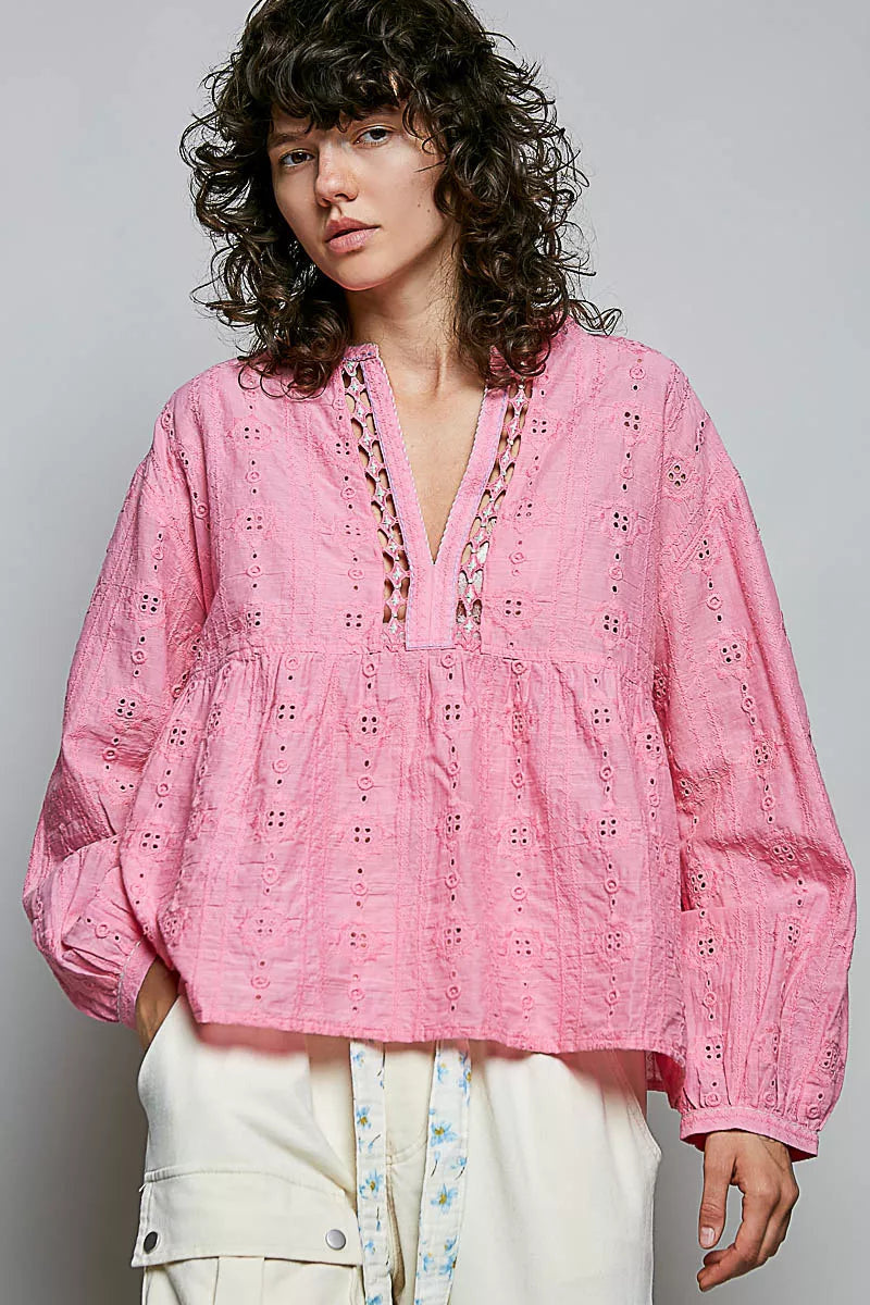 Candy pink eyelet blouse styled on model, side angle