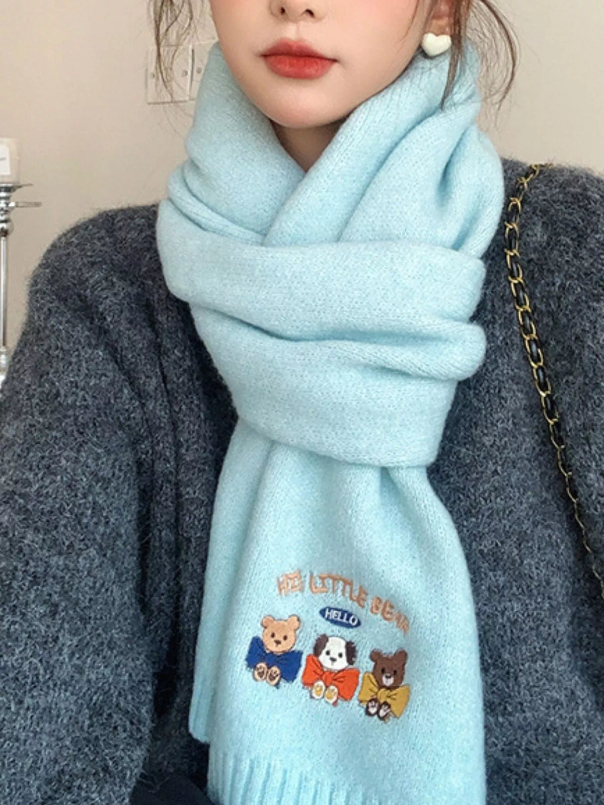 Embroidered cartoon warm scarf laid flat to show length
