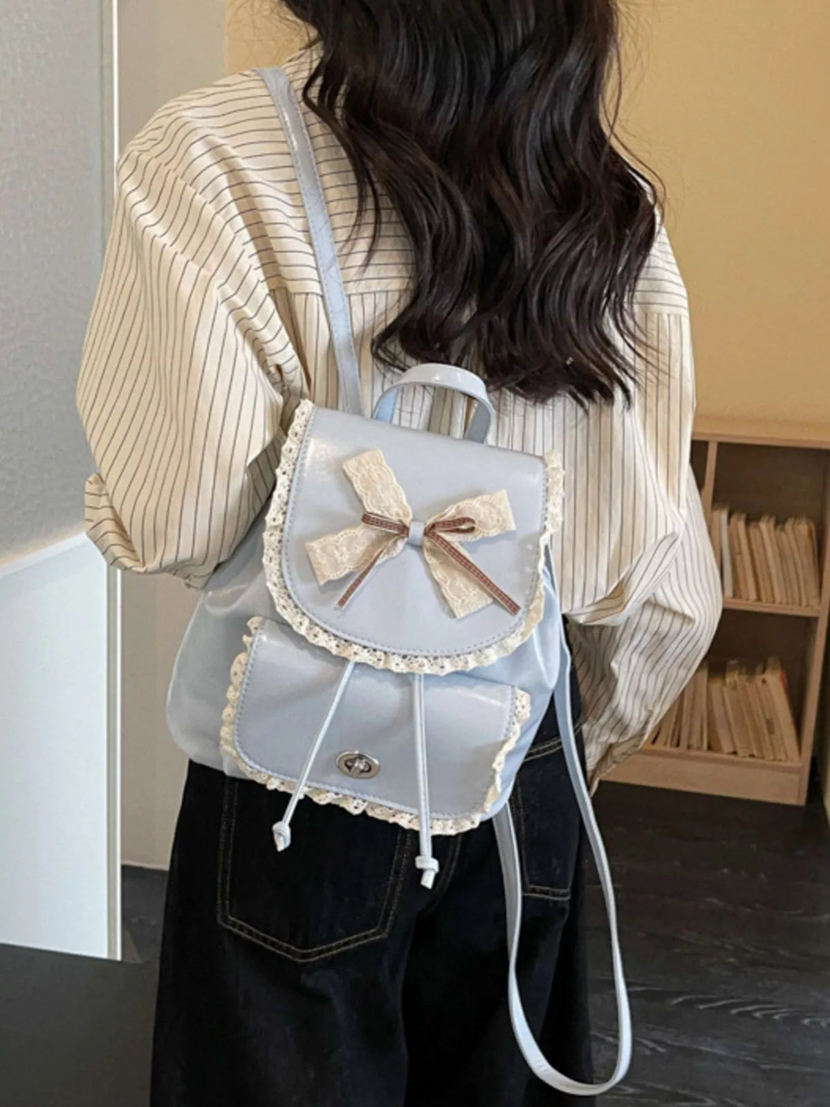 Blue lace bow mini backpack shoulder strap detail