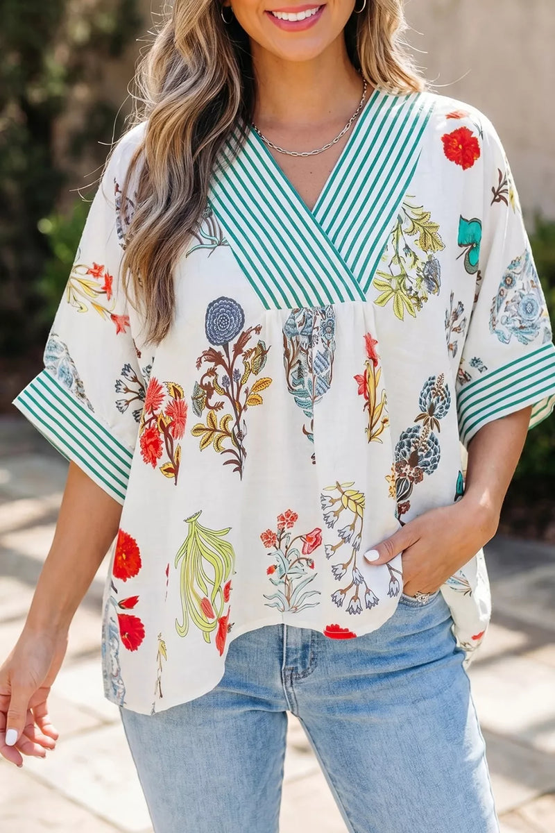 Pastel blue floral blouse with striped contrast trim