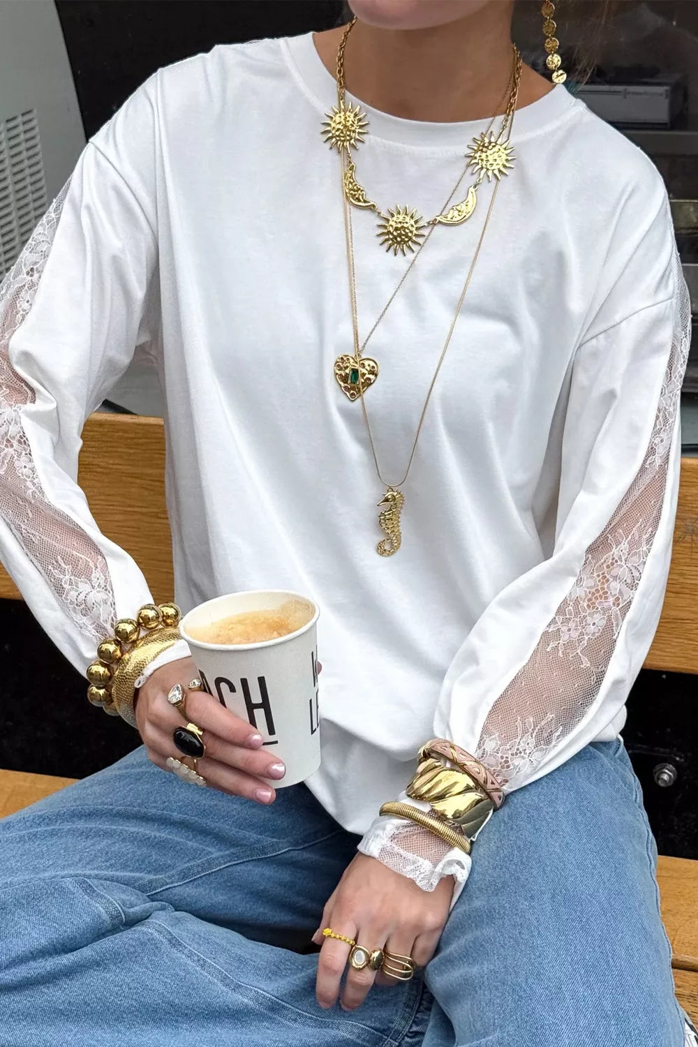Lace patchwork detail on the white long sleeve top