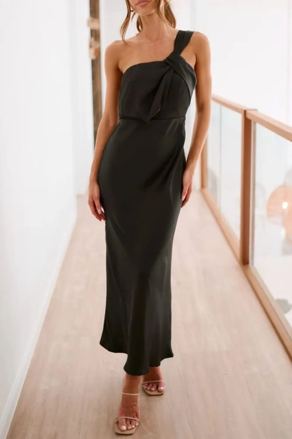 Black single shoulder maxi dress close up