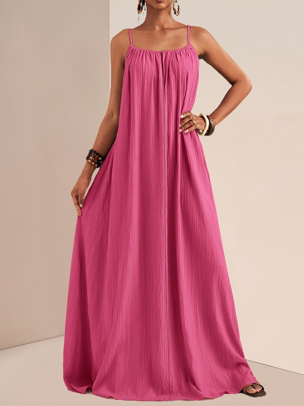 Flowy maxi dress styled with a straw bag