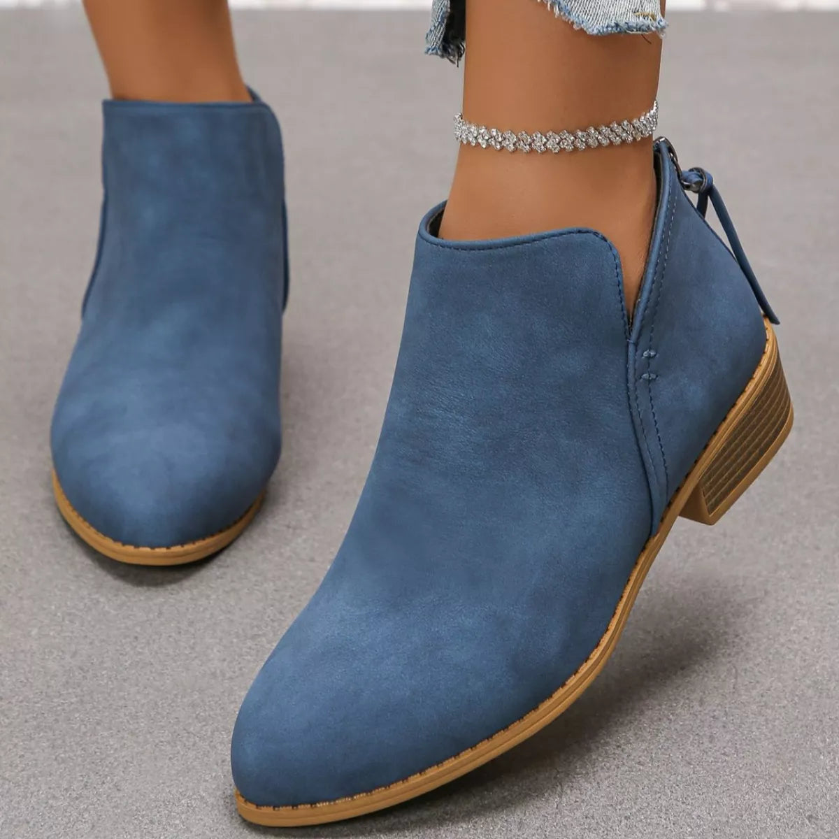 Point toe block heel ankle boots paired with denim