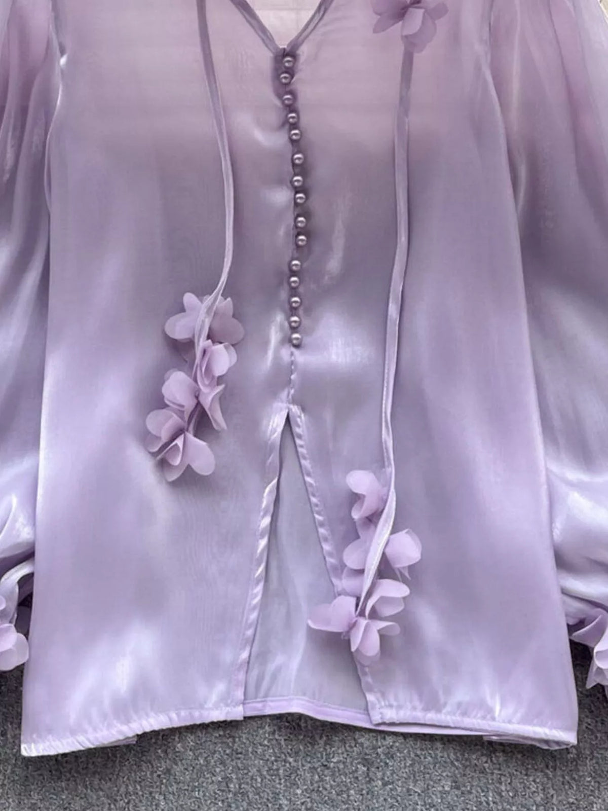 White sheer floral shirt with long sleeves on a model