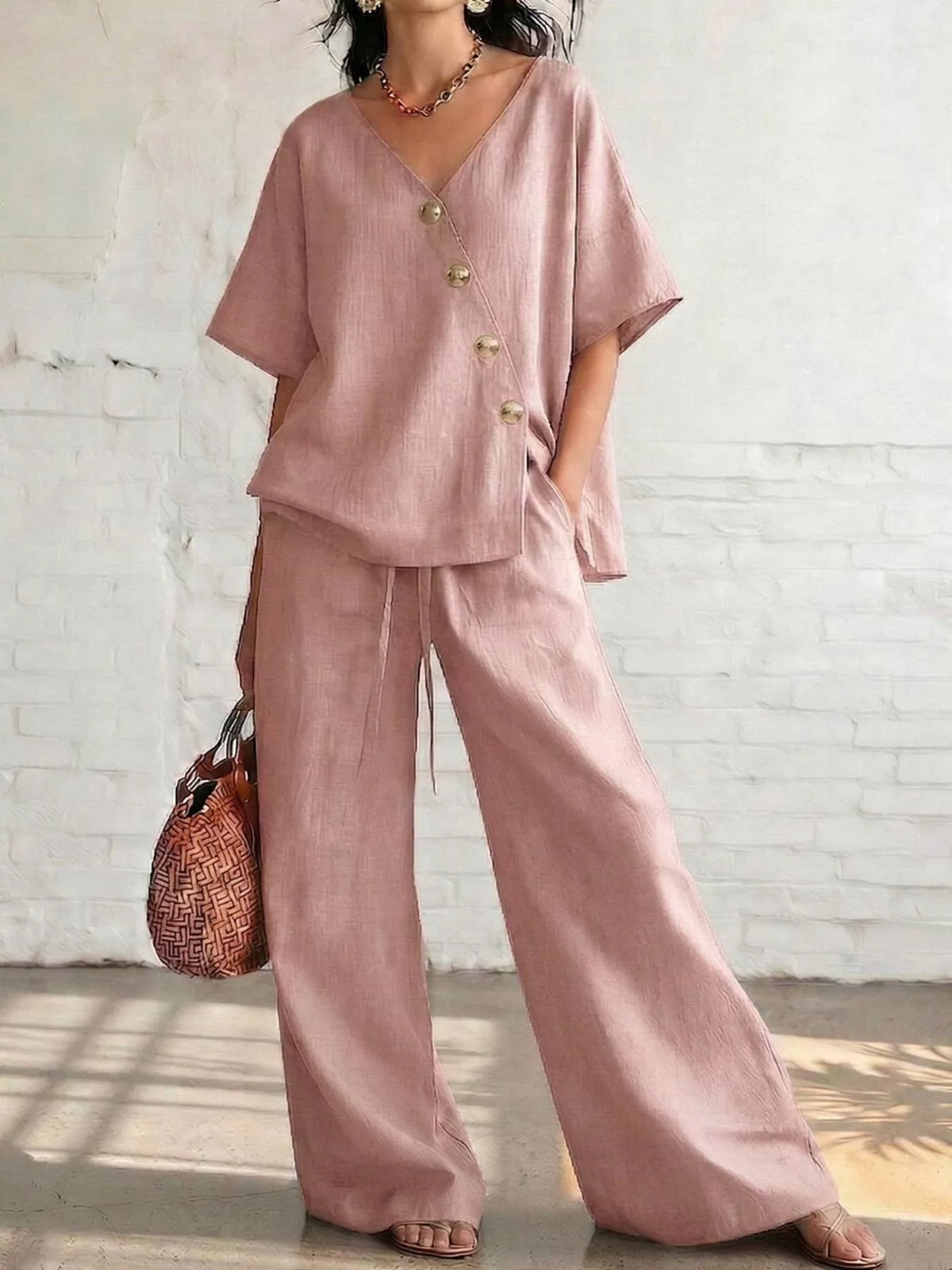 Two piece set in black worn with the top tied at the waist