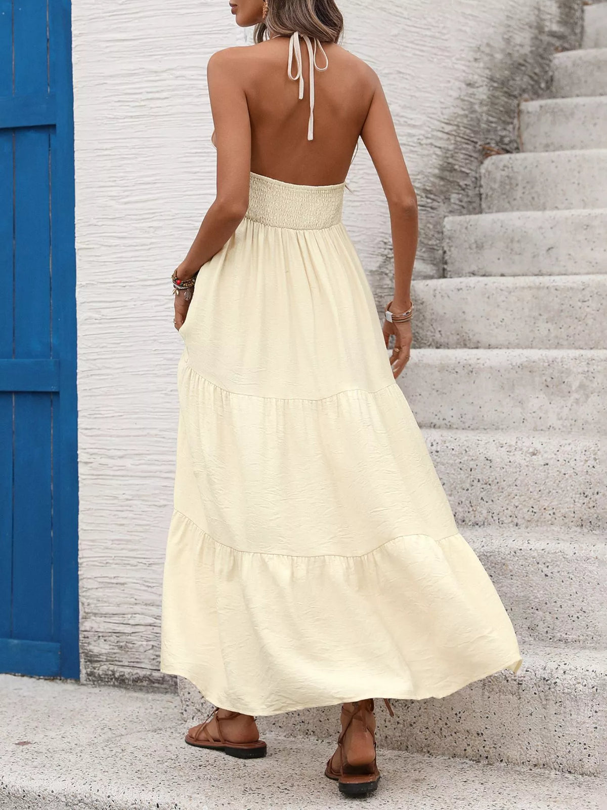 Pastel yellow halter neck tiered maxi dress back view