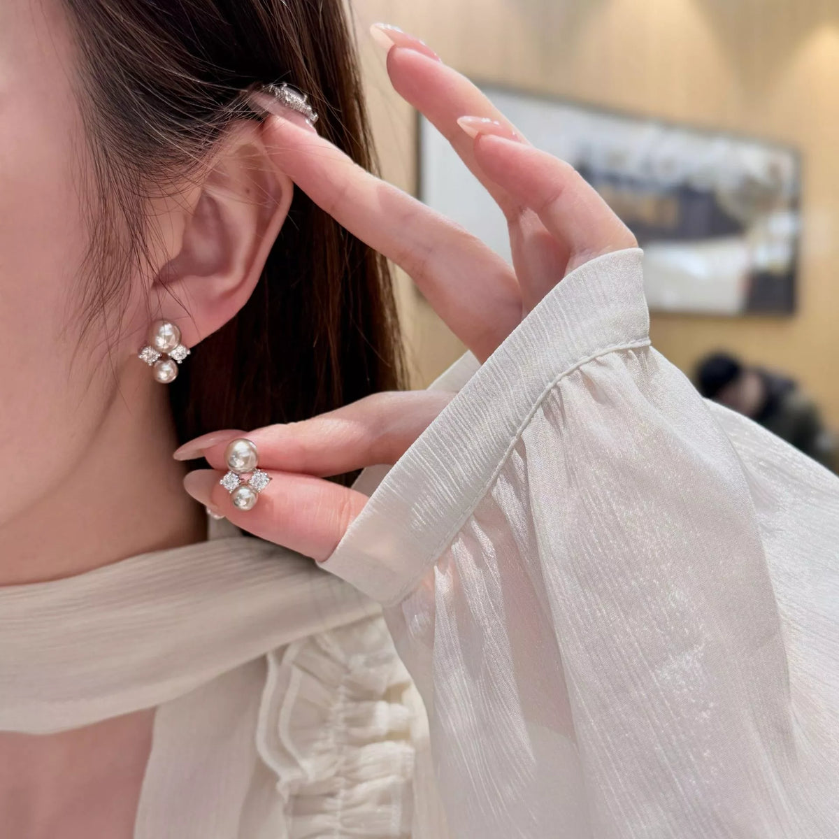 Silver pearl stud earrings close up