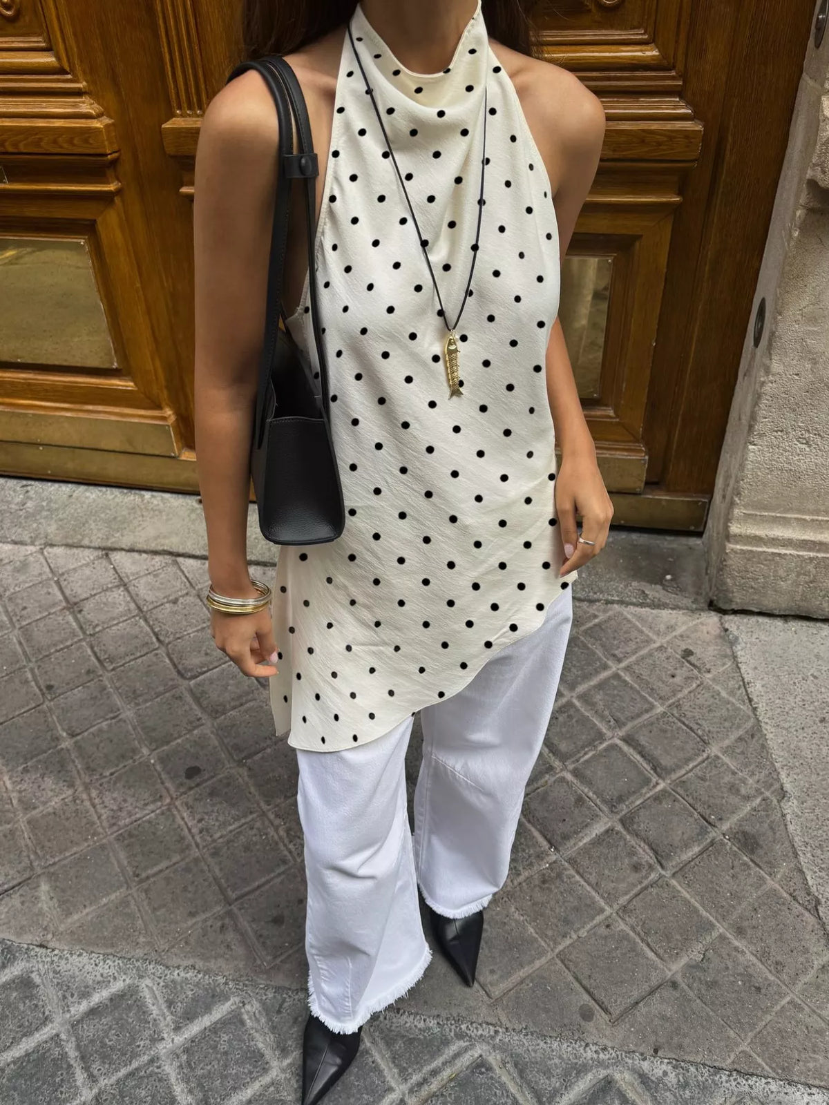 Black polka dot halter top shown from the back