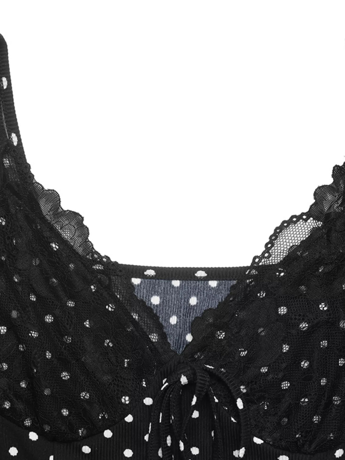 Model wearing black polka dot mini dress, full length