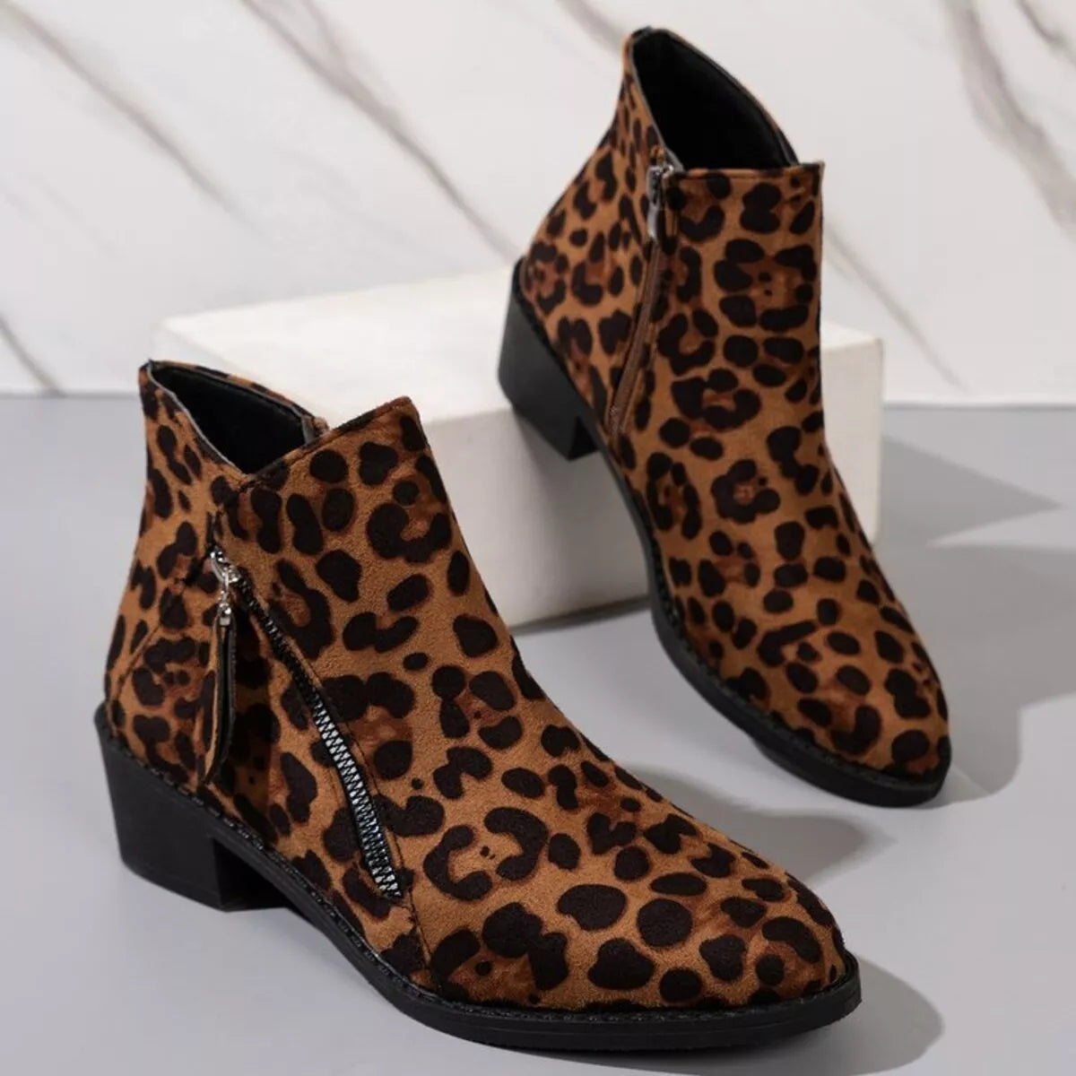 Leopard point toe block heels boots pair standing together