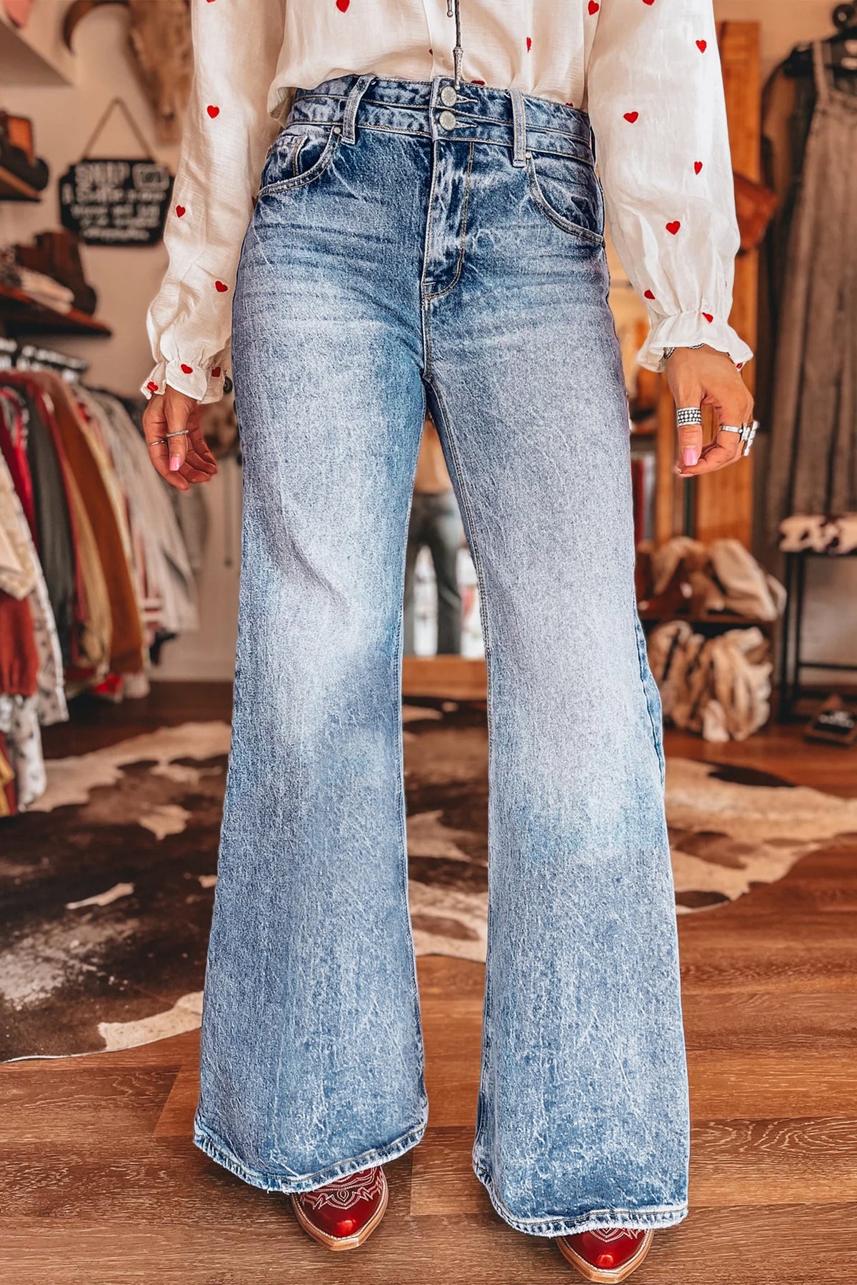 Close up pocket detail of blue acid wash flare jeans