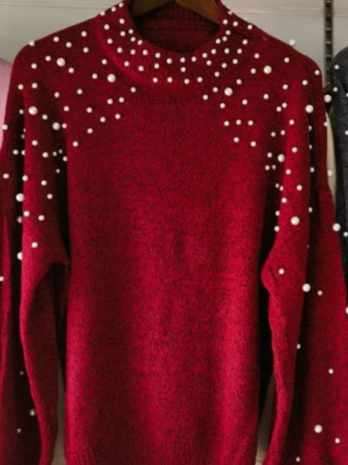 Close up of pearl accents at the mock neckline