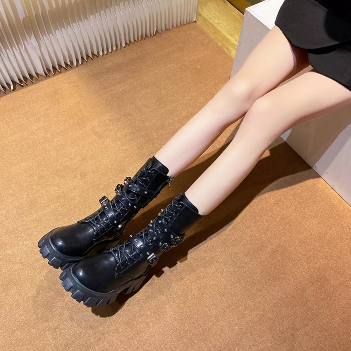 Buckled lace up combat boots angled pair