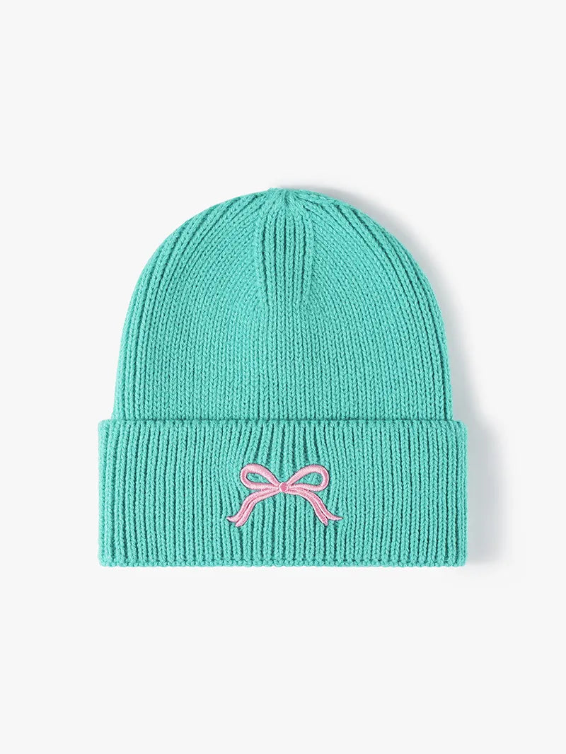 Knit beanie showing folded cuff and bow detail