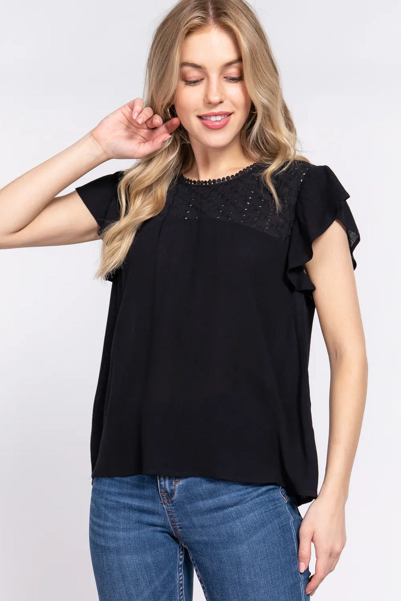 Ruffle short sleeve crochet blouse in black front view on model