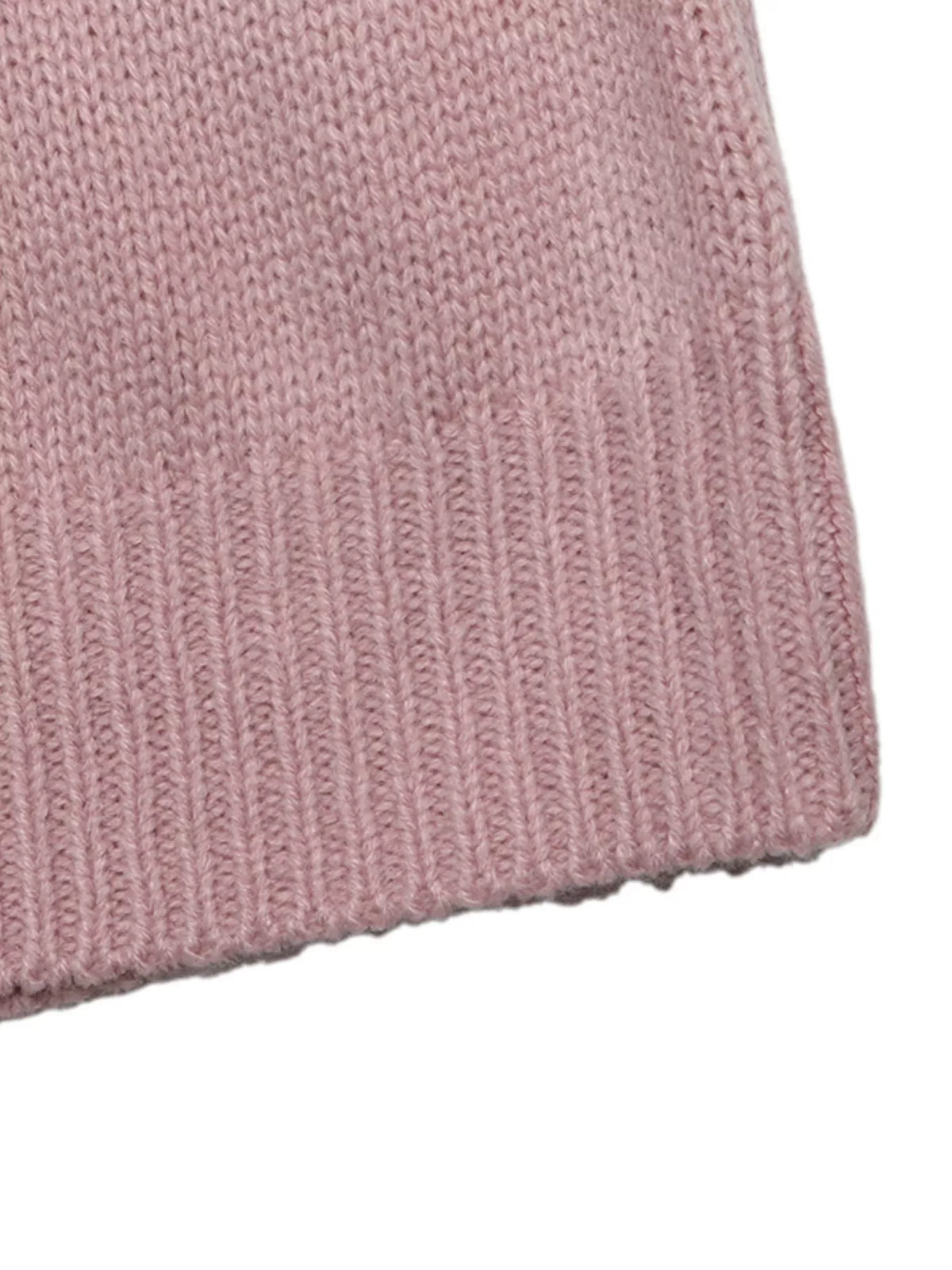 V neck sweater layered over a fitted top