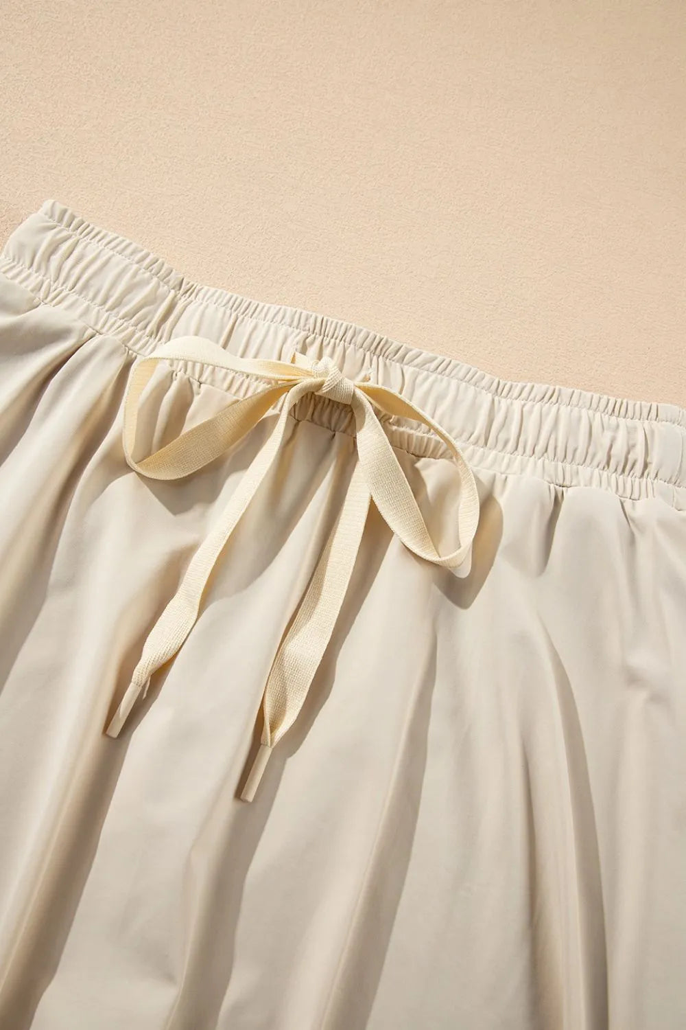 Drawstring high waist lined active skort three quarter view