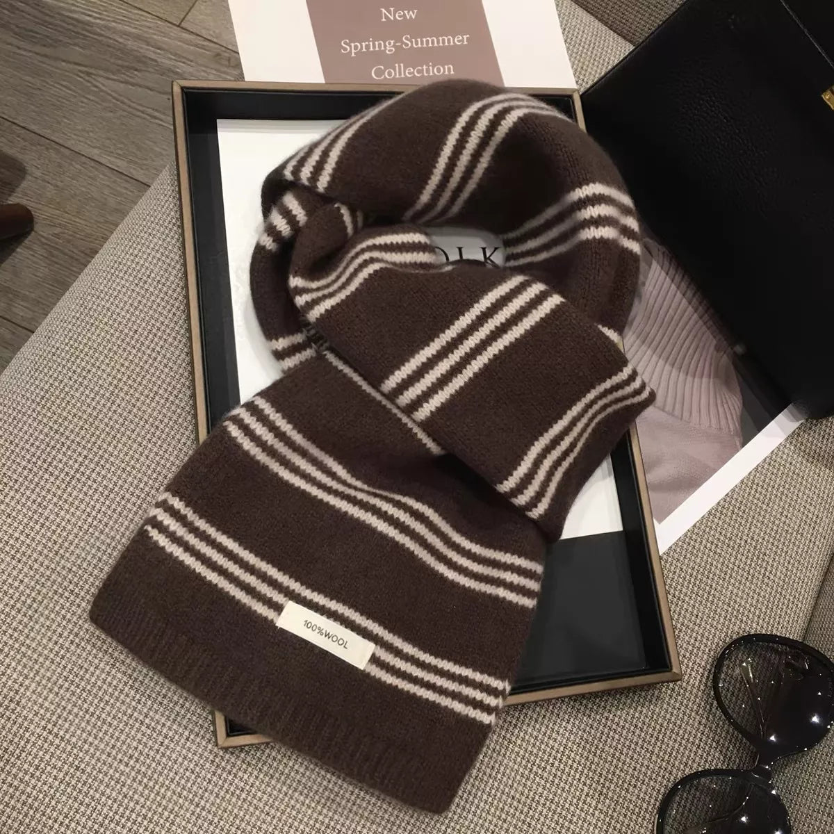 Brown wool stripe scarf draped over the shoulders