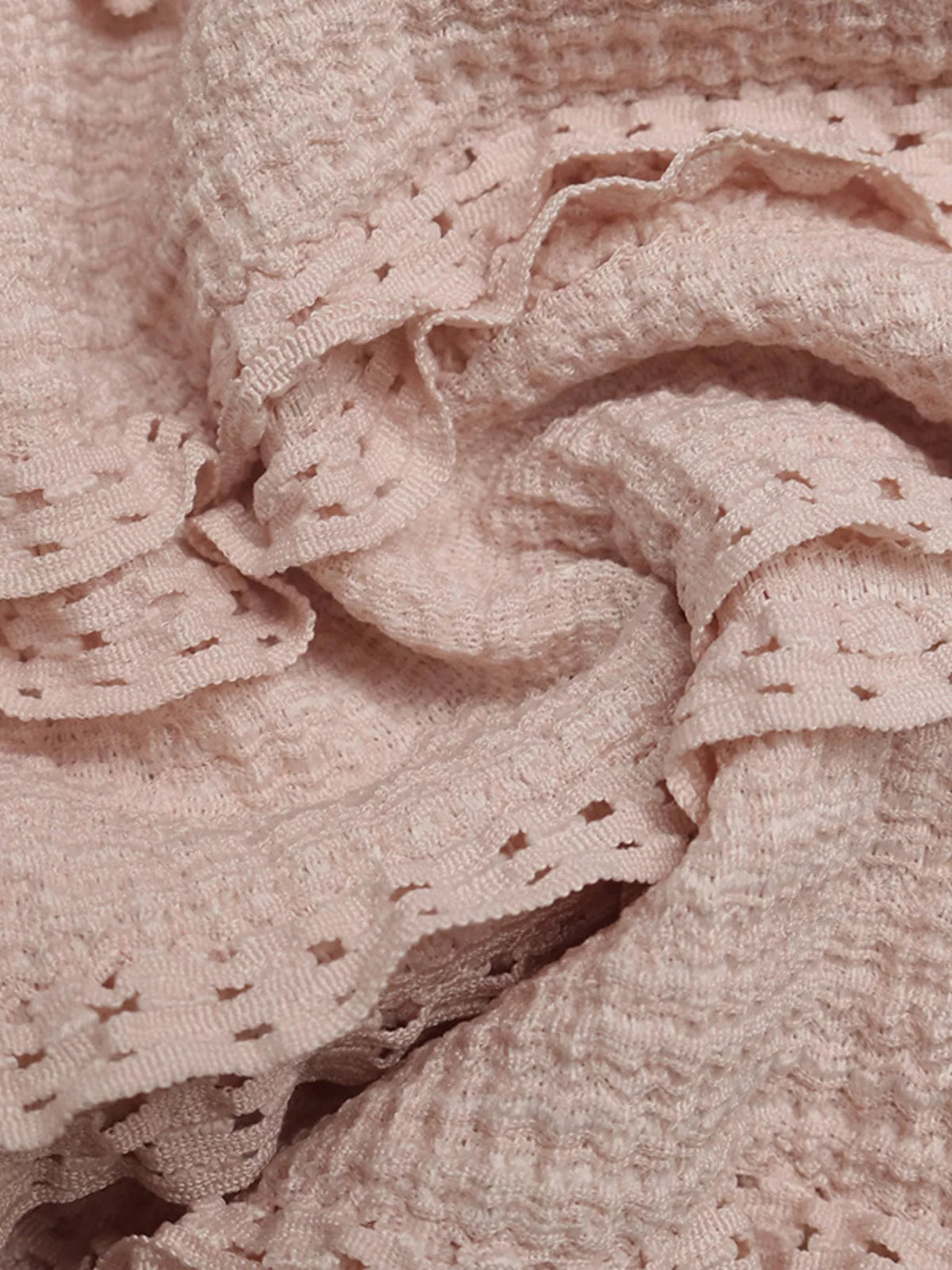 Pink halter neck textured romper angled view