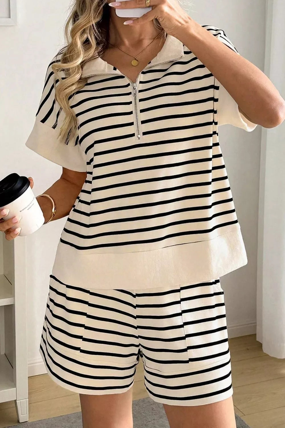 Beige coordinated half zip top and shorts set styled