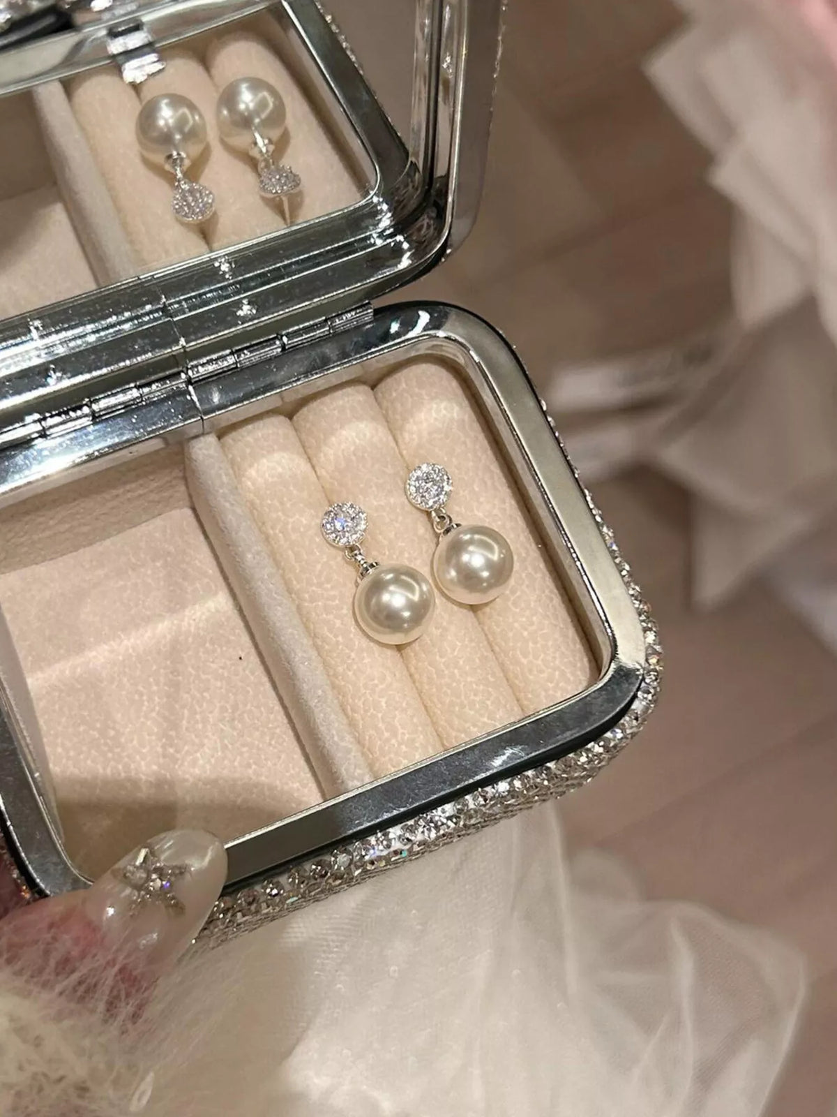 Cream pearl drop earrings front view