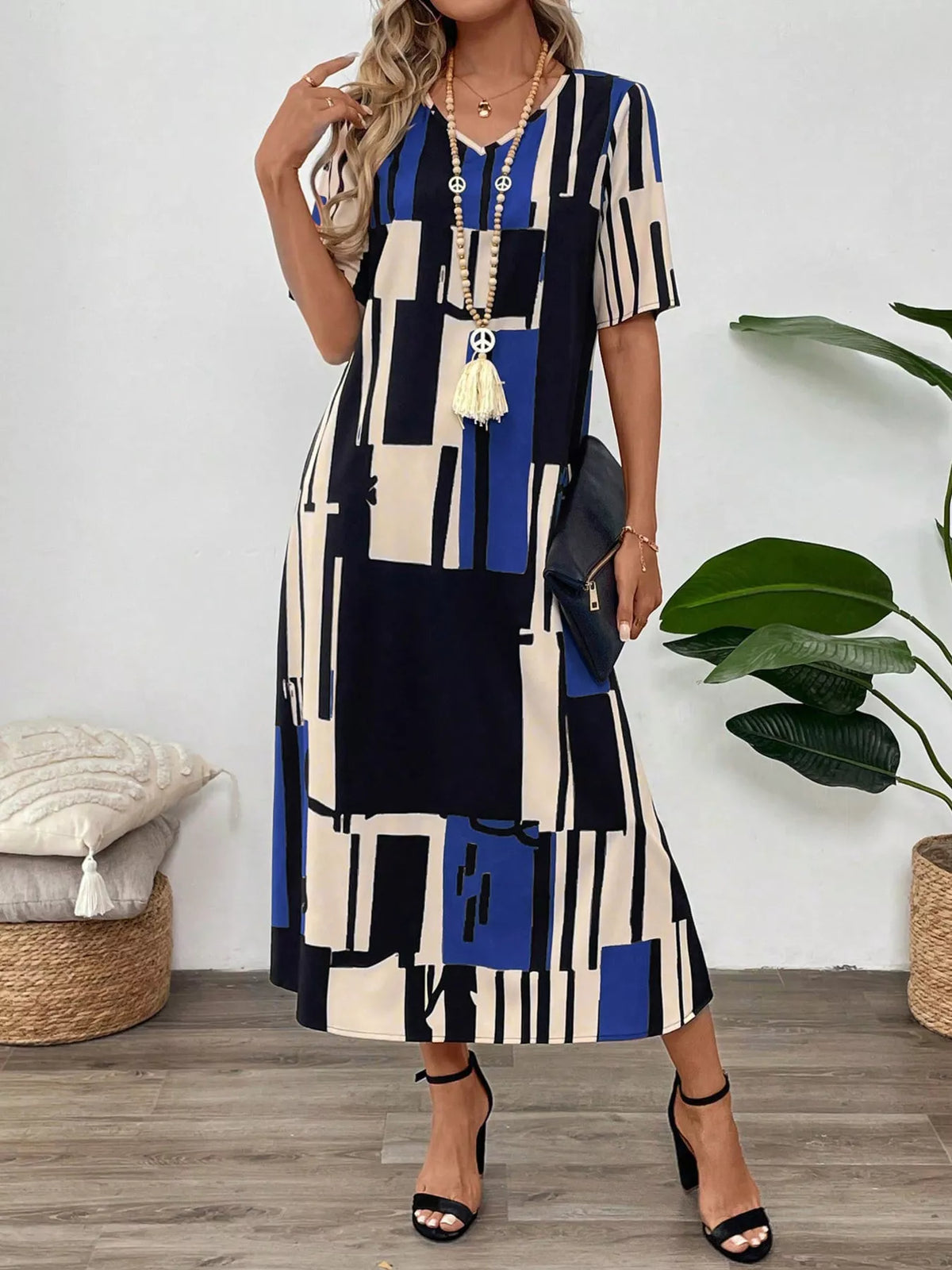 Abstract geometric print v neck midi dress angled view