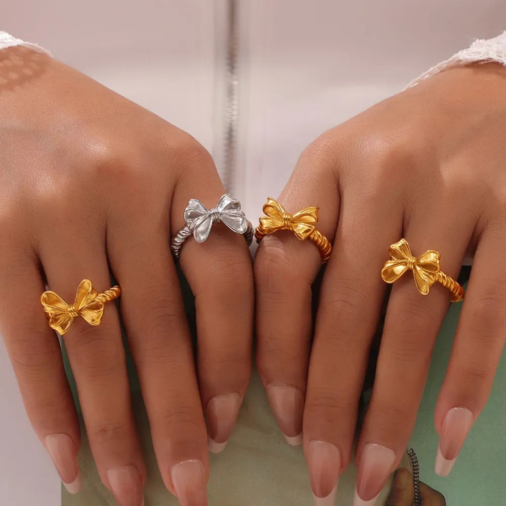 Twisted bow ring held between fingers