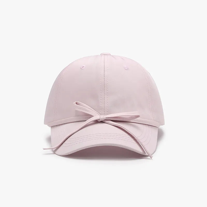 Tied bow cap styled for a casual everyday look