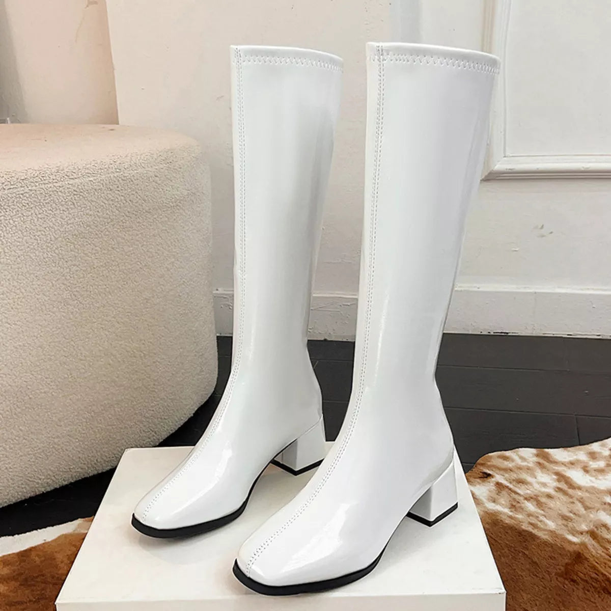 Square toe block heel boots in Black, angled three quarter view
