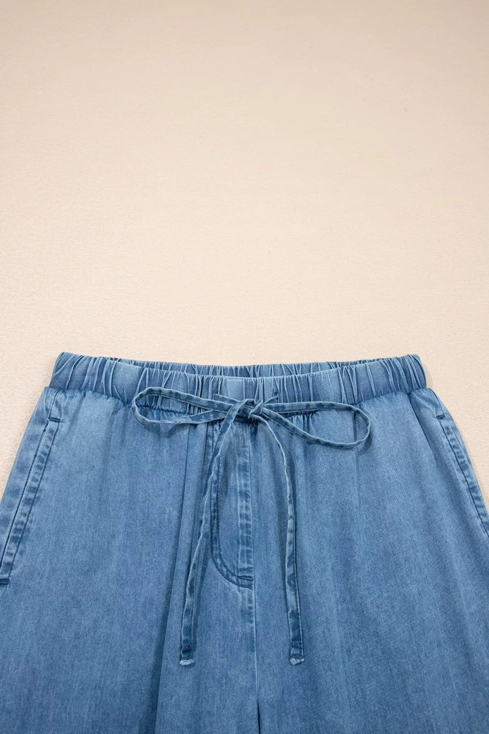 Ruffled hem wide leg chambray pants standing pose