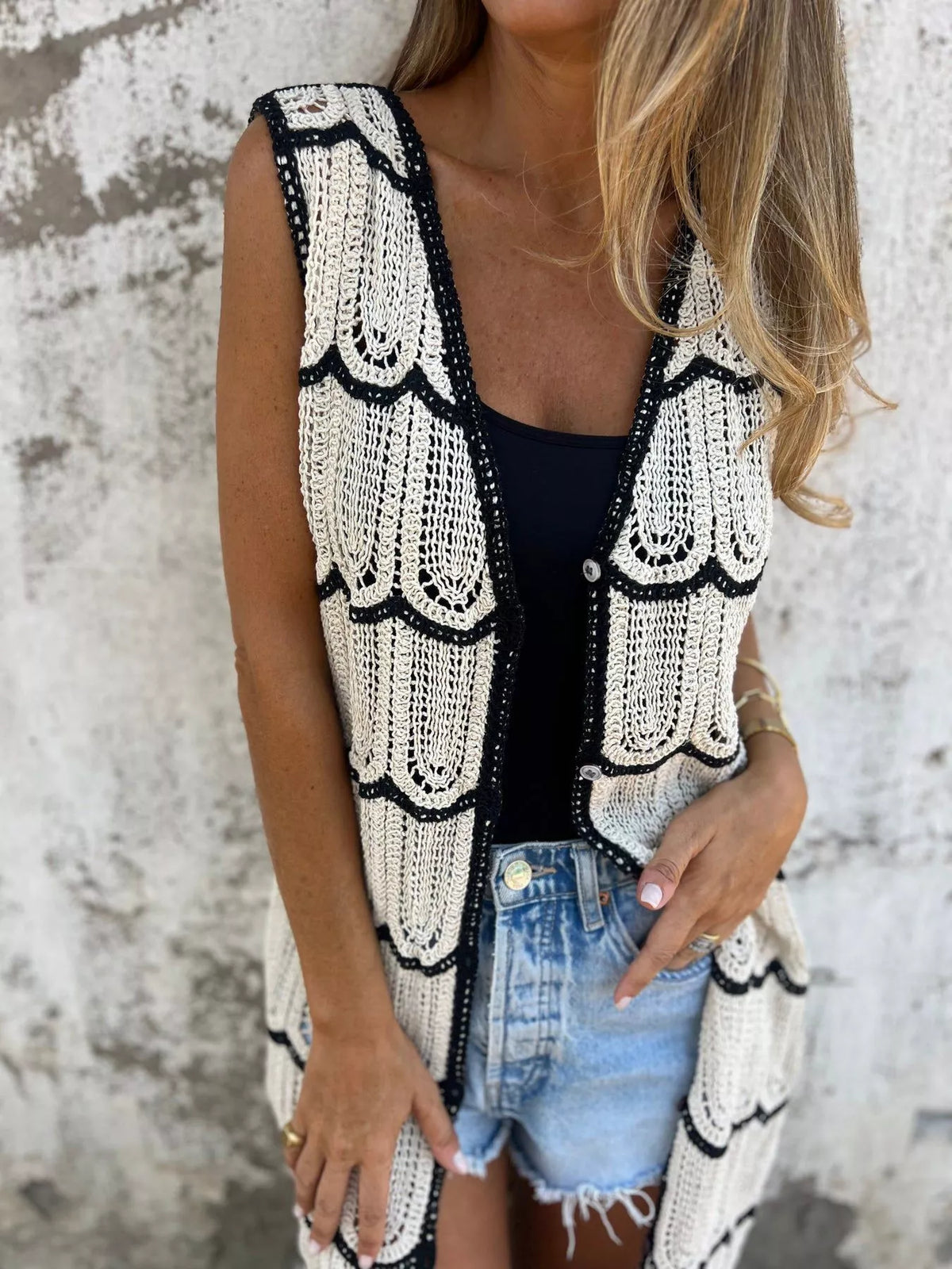 Button front detail on the sleeveless crochet cardigan
