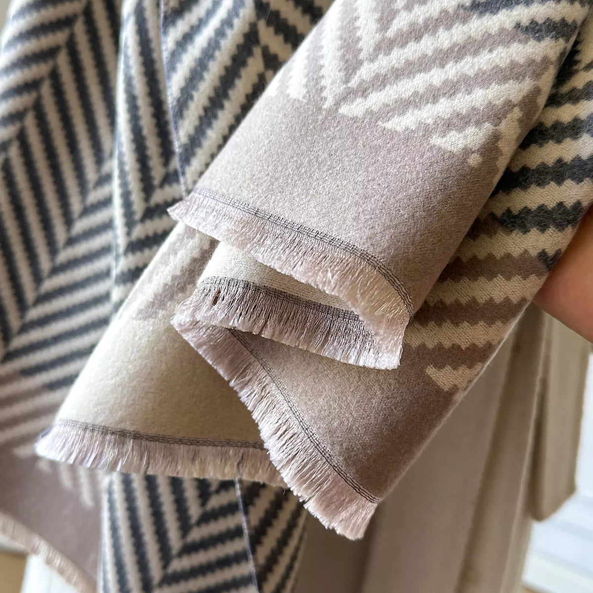 Close view of the raw hem edge on the soft scarf
