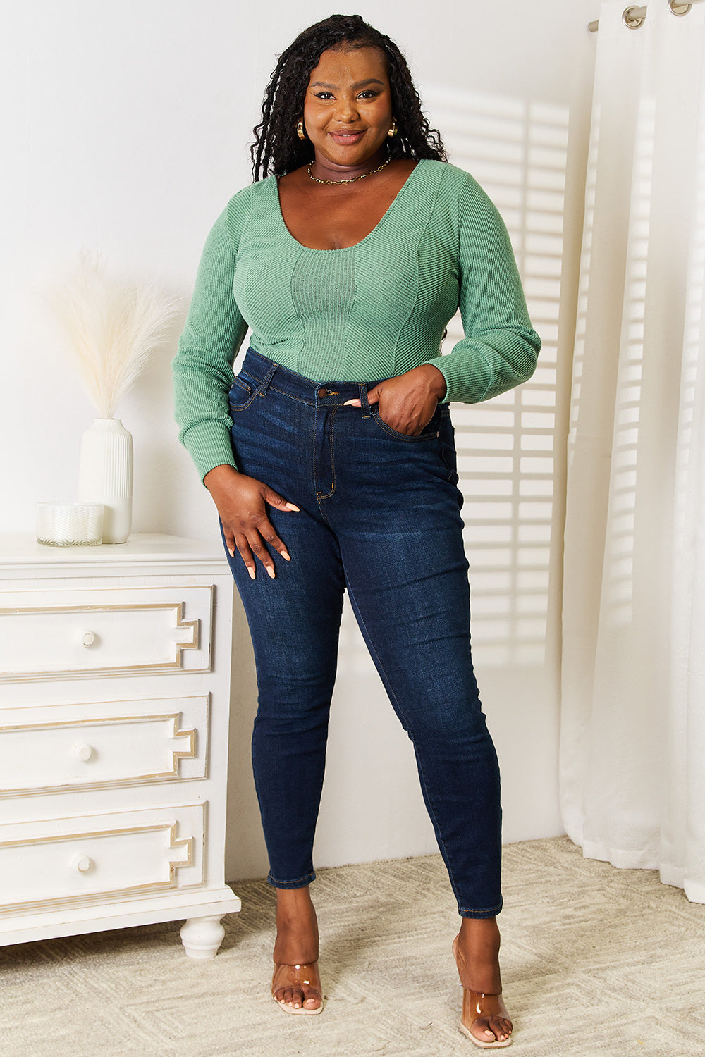 Close up of stretch fabric on green long sleeve top