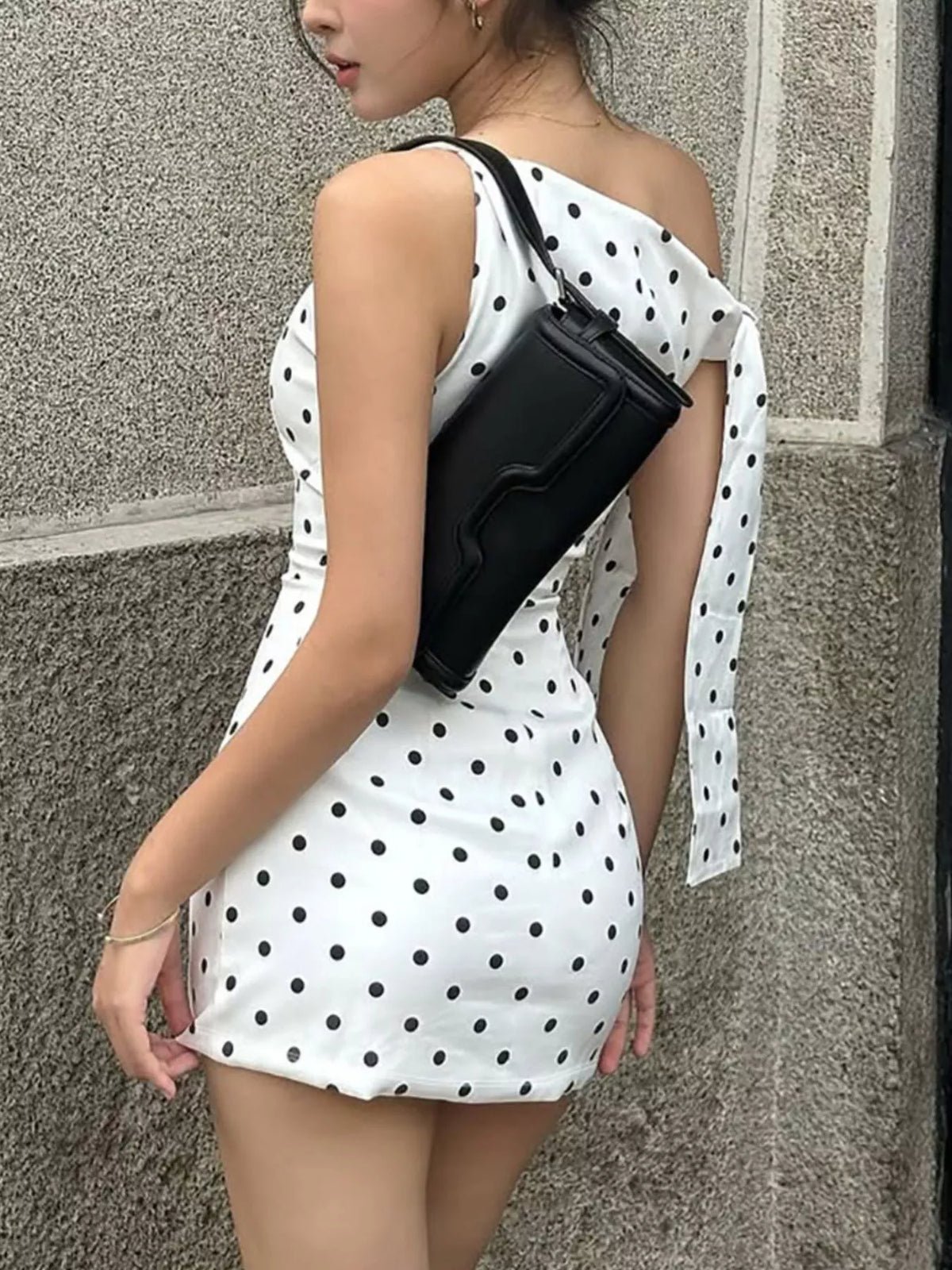 Sable polka dot bow accent mini dress in black, front view