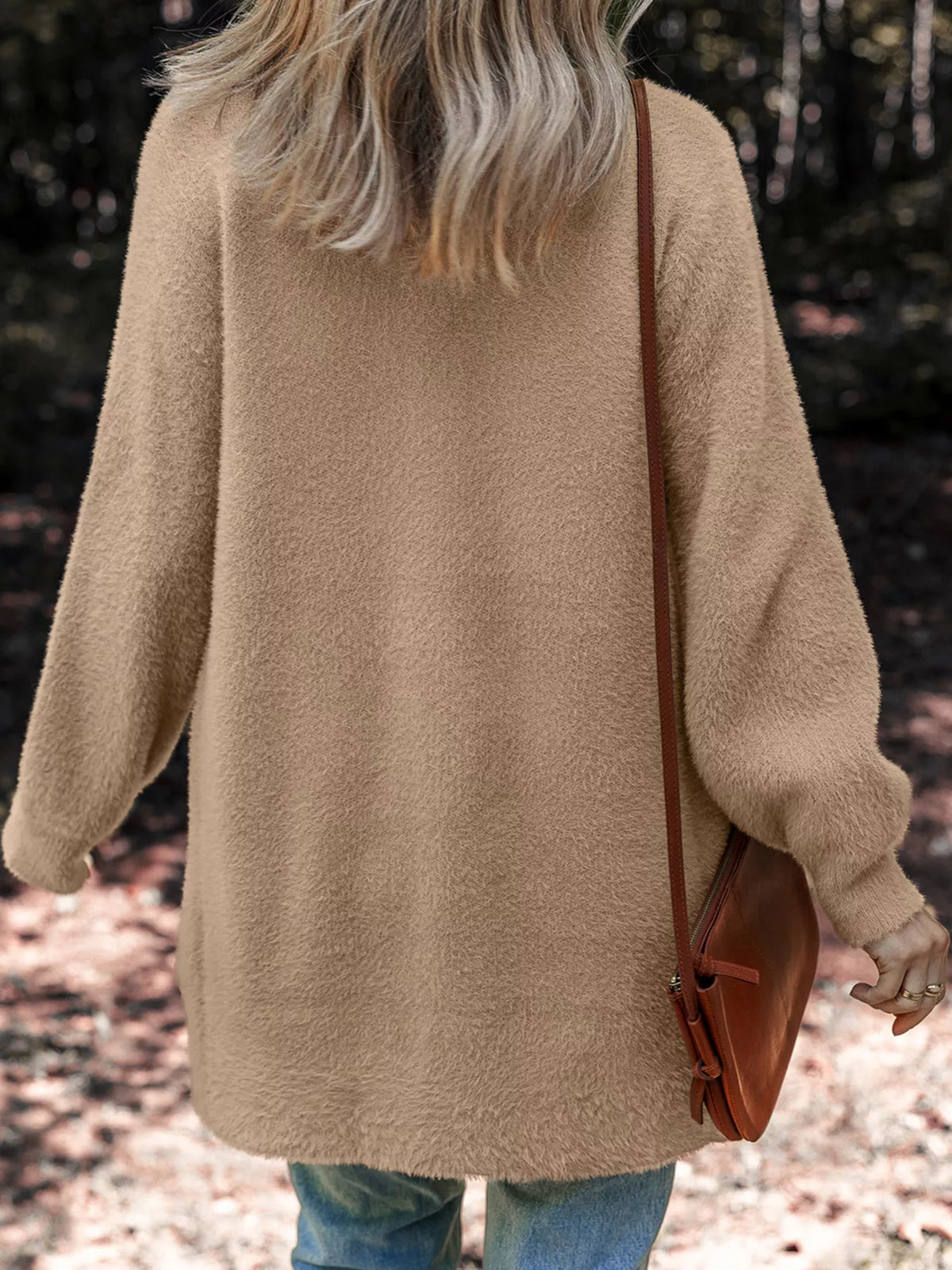 Fuzzy cardigan worn open showing front pockets