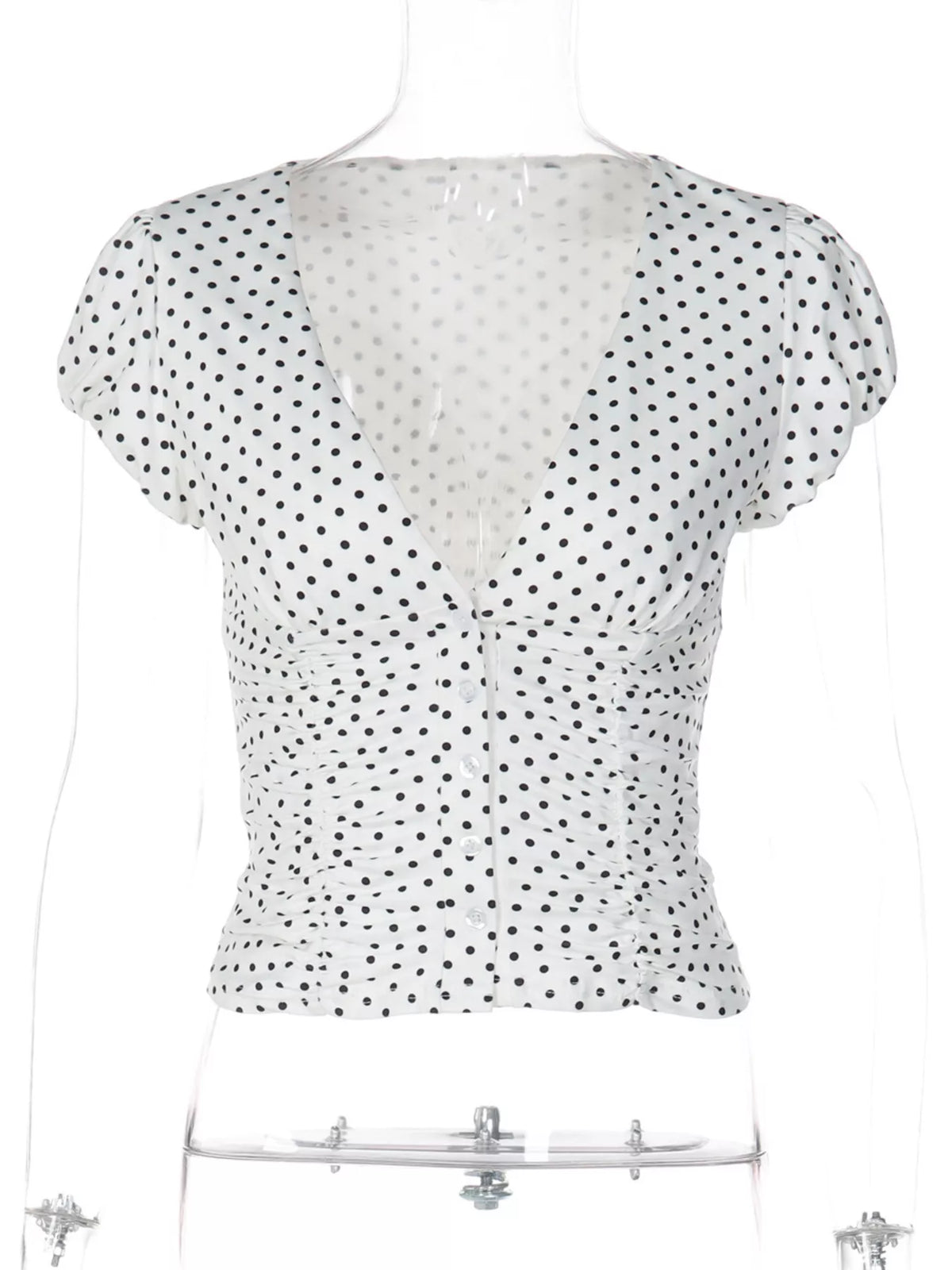 Polka dot V neck top shown at an angle