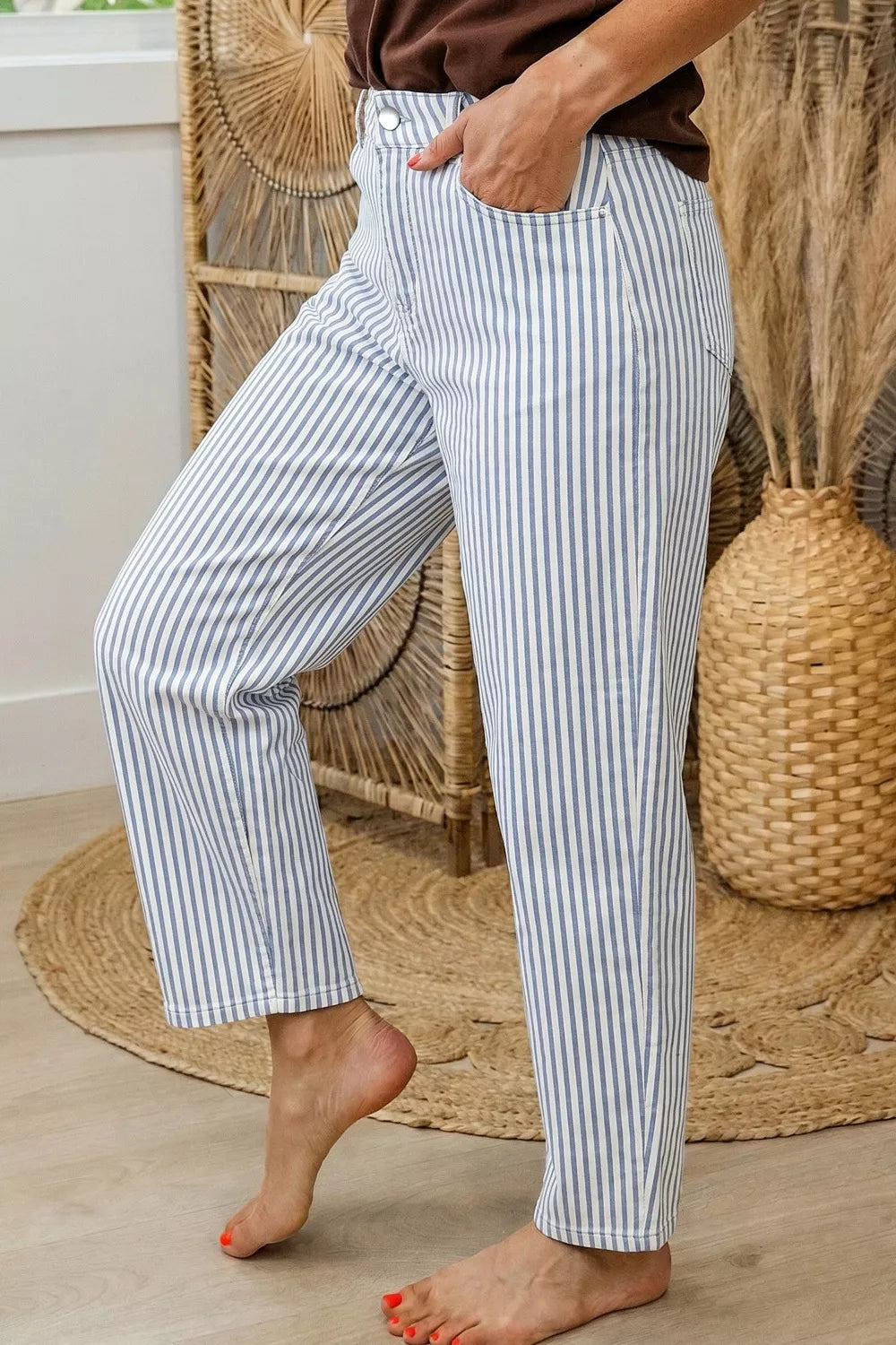 Back view of striped barrel leg jeans with pockets