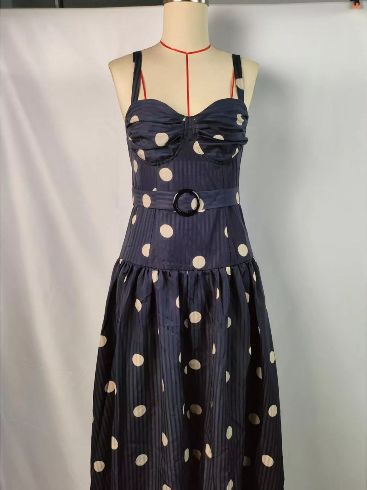 Black polka dot sweetheart neck midi dress side view