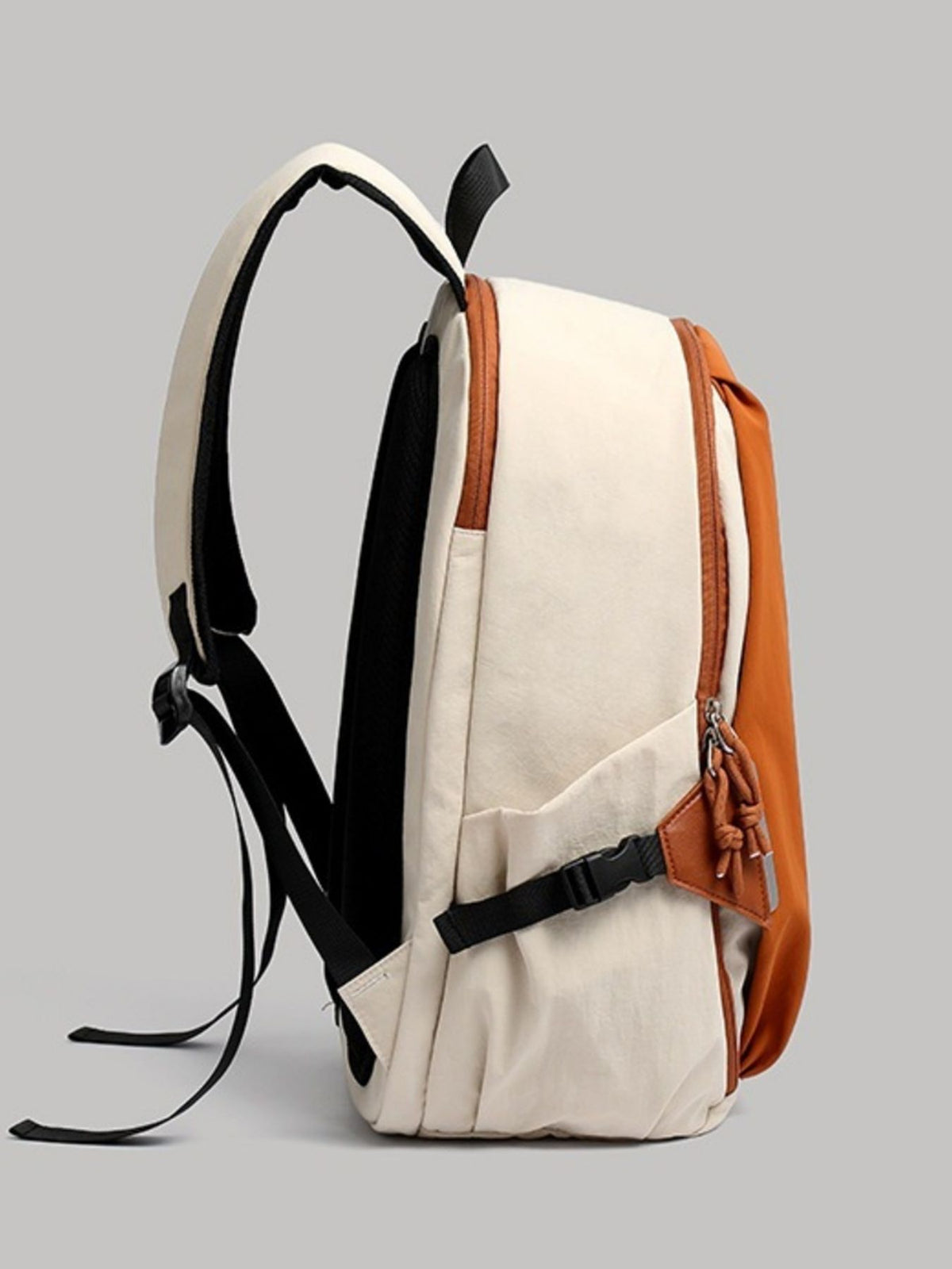 Orange color block nylon backpack worn on the shoulders