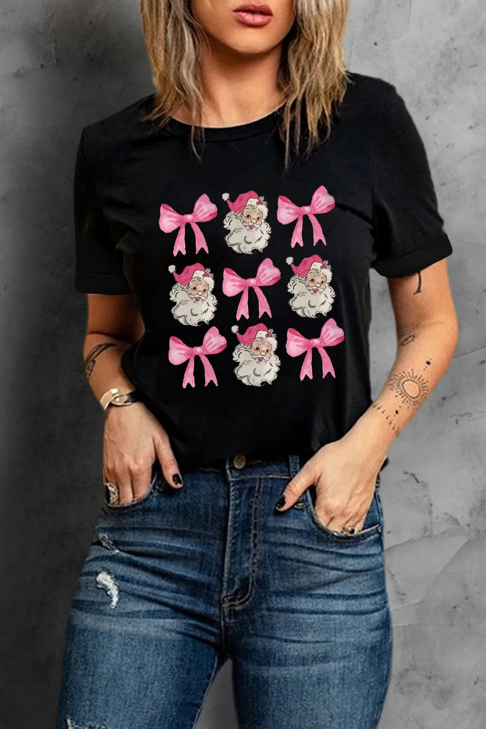 Black graphic holiday top showing Santa print detail